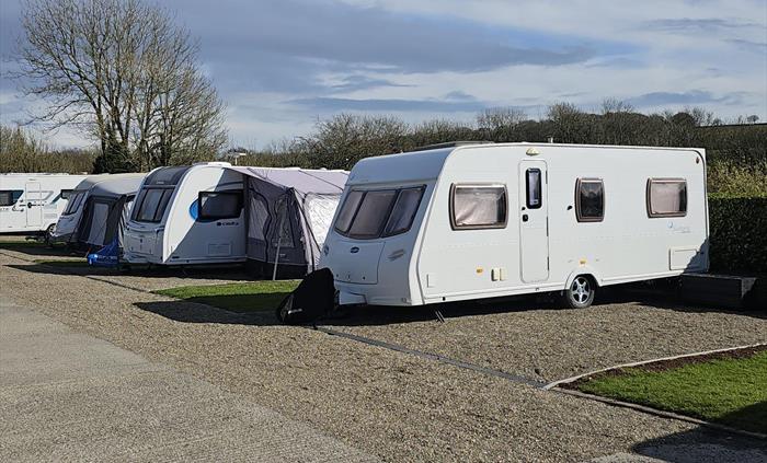 Touring field pitches, fully hard standing with small grass area to side.